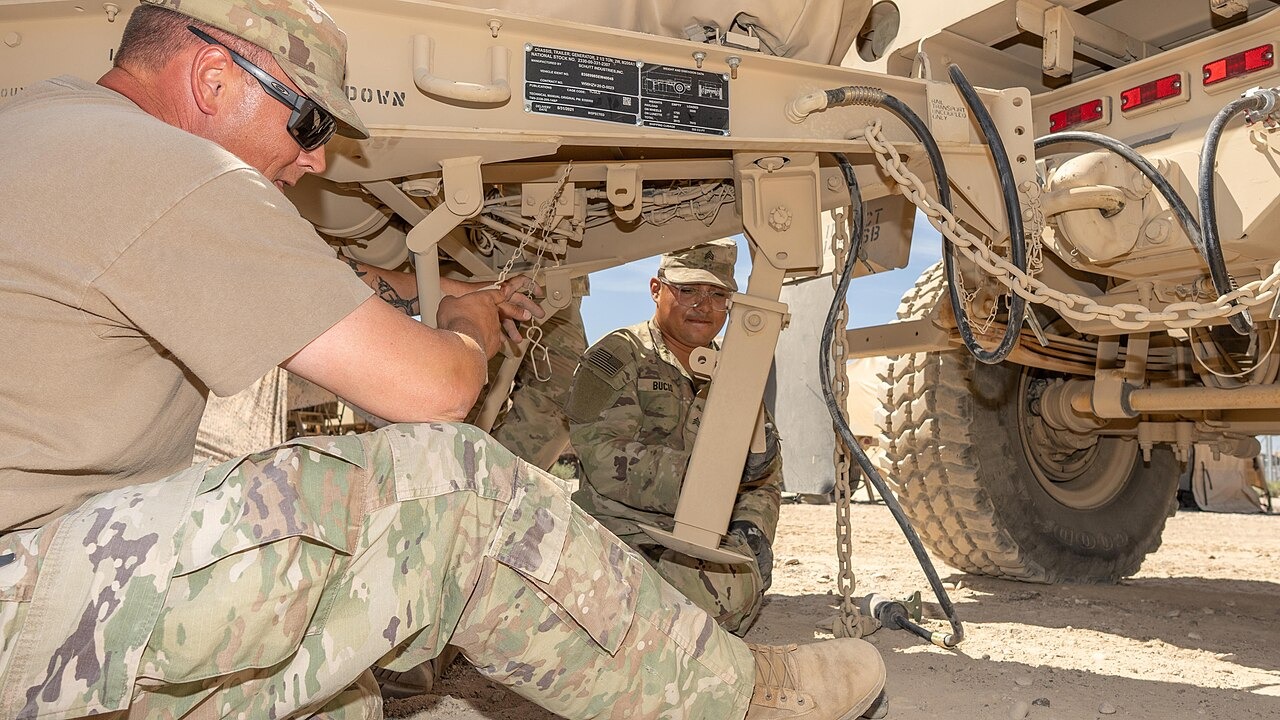 File photo: Soldiers conduct maintenance work beneath a military vehicle during Army training. Illustrative context; not a photograph of the reported event.